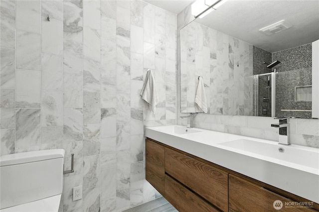 2500 171st Ave SE, Bellevue, WA 98008 - bathroom with double vanity, a shower stall, and tile walls