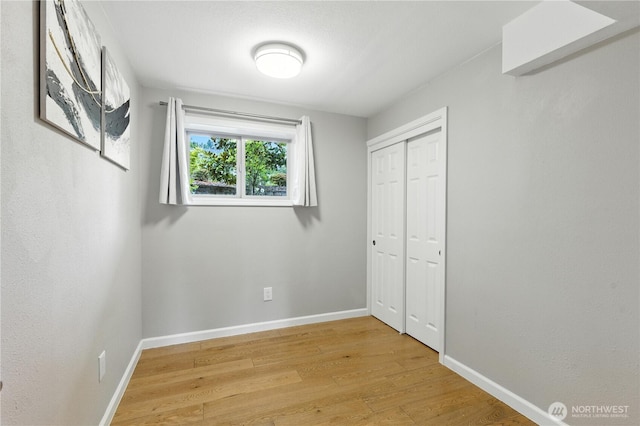 2500 171st Ave SE, Bellevue, WA 98008 - unfurnished bedroom with light wood finished floors and a closet