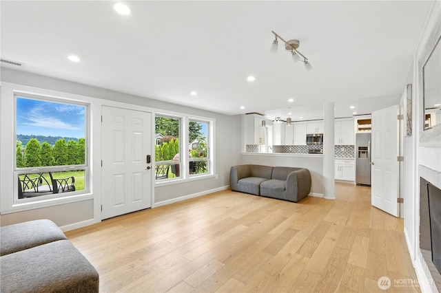 2500 171st Ave SE, Bellevue, WA 98008 - living area with light wood finished floors, recessed lighting, and a fireplace