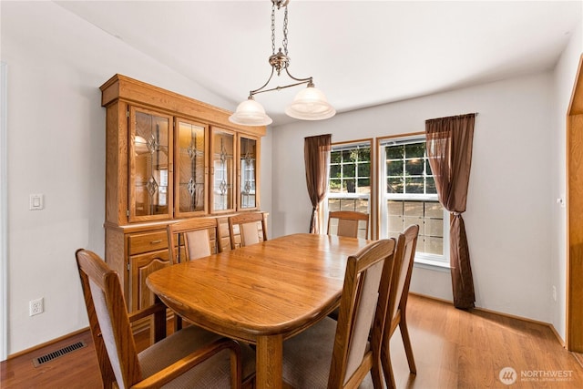 301 Salmonberry Ln, Friday Harbor, WA 98250 - dining room featuring light wood-type flooring and vaulted ceiling
