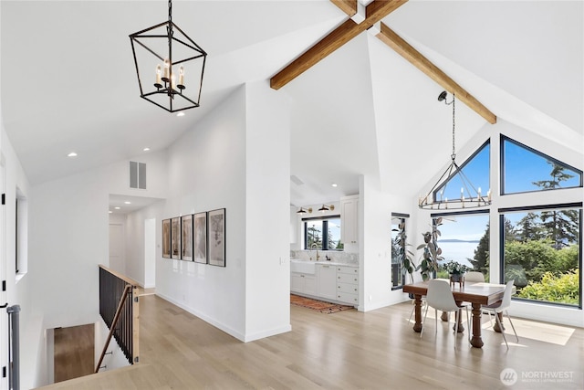 405 Bayside Rd, Bellingham, WA 98225 - dining area featuring high vaulted ceiling, beam ceiling, a chandelier, light wood finished floors, and recessed lighting