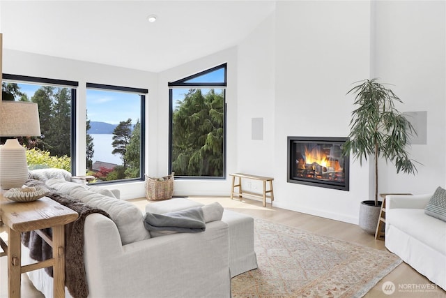 405 Bayside Rd, Bellingham, WA 98225 - living room with plenty of natural light, a glass covered fireplace, wood finished floors, and recessed lighting