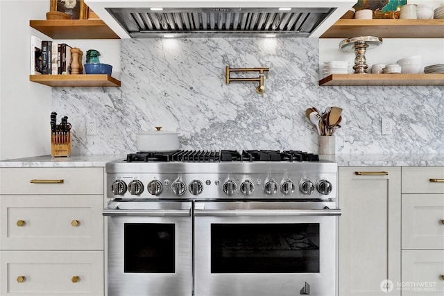 405 Bayside Rd, Bellingham, WA 98225 - kitchen with open shelves, range with two ovens, ventilation hood, and decorative backsplash