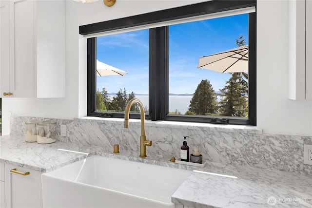 405 Bayside Rd, Bellingham, WA 98225 - kitchen view of white cabinetry, tasteful backsplash, and light stone countertops