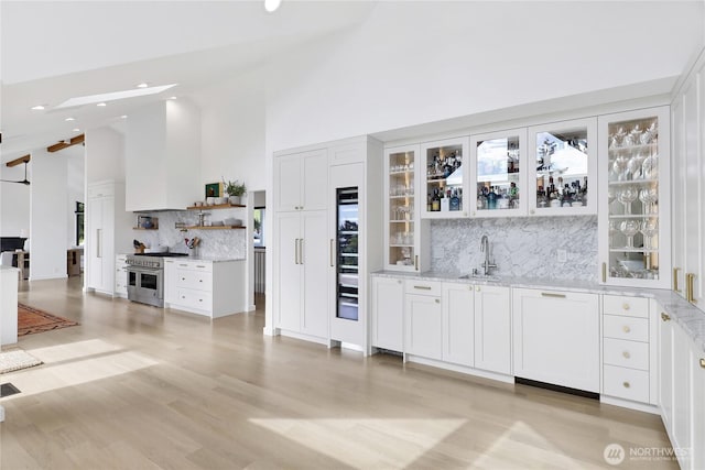 405 Bayside Rd, Bellingham, WA 98225 - indoor wet bar featuring double oven range, tasteful backsplash, recessed lighting, high vaulted ceiling, and light wood-style flooring