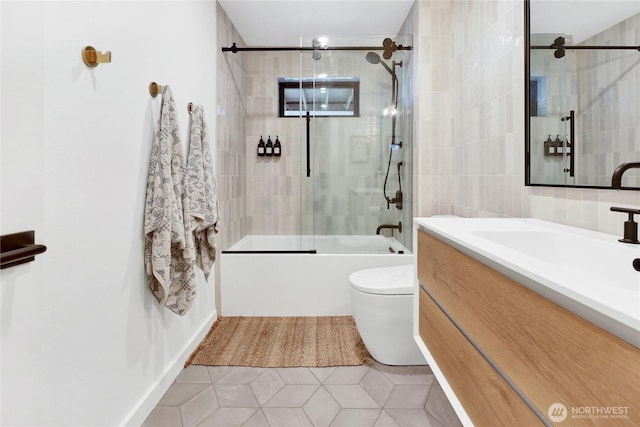 405 Bayside Rd, Bellingham, WA 98225 - full bath featuring shower / bath combination with glass door, vanity, tile patterned flooring, and tile walls