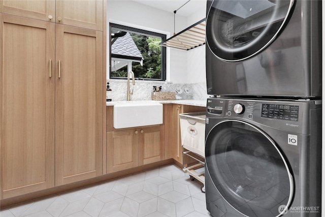 405 Bayside Rd, Bellingham, WA 98225 - laundry area with stacked washer and clothes dryer, cabinet space, and light tile patterned floors