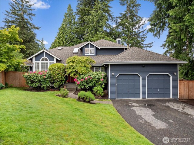 8221 122nd Ave NE, Kirkland, WA 98033 - view of front of house featuring roof with shingles, asphalt driveway, an attached garage, and a chimney