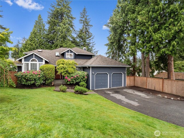 8221 122nd Ave NE, Kirkland, WA 98033 - view of front of home with an attached garage, driveway, a shingled roof, and a chimney
