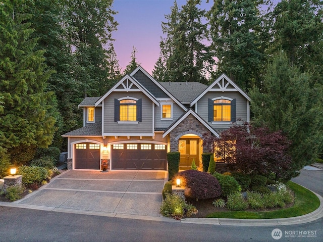 2507 101st Ln NE, Bellevue, WA 98004 - craftsman-style house featuring stone siding, an attached garage, and driveway