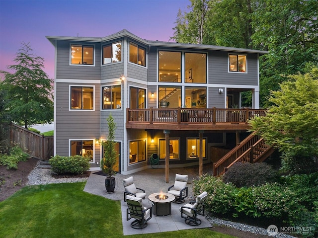 2507 101st Ln NE, Bellevue, WA 98004 - back of house at dusk featuring an outdoor fire pit, a patio area, stairs, and a deck