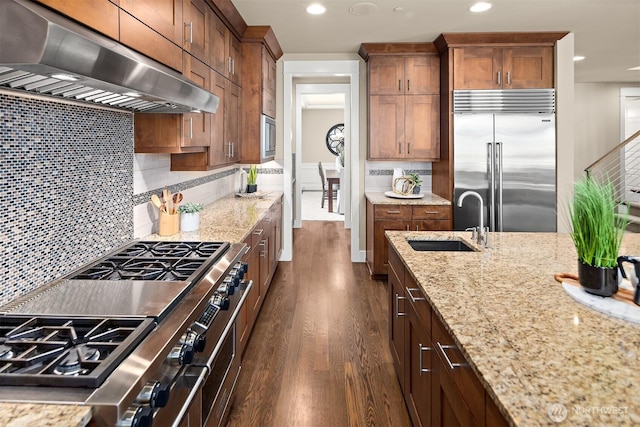 2507 101st Ln NE, Bellevue, WA 98004 - kitchen with exhaust hood, high quality appliances, dark wood-style floors, light stone countertops, and tasteful backsplash
