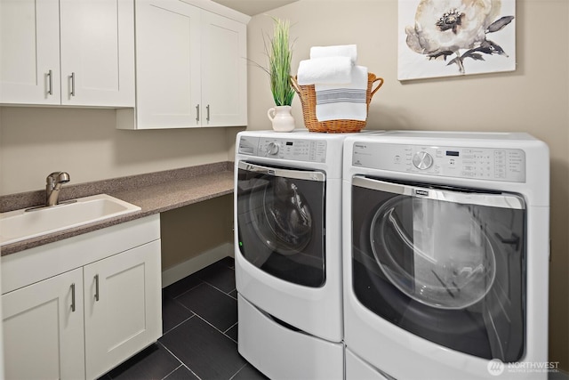 2507 101st Ln NE, Bellevue, WA 98004 - washroom featuring washing machine and dryer, cabinet space, and dark tile patterned flooring