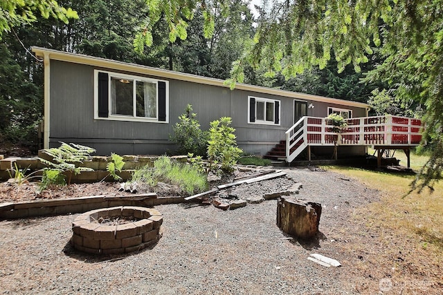 5845 Alpha Ln, Freeland, WA 98249 - manufactured / mobile home with an outdoor fire pit and a deck