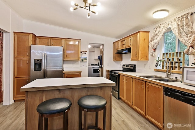 5845 Alpha Ln, Freeland, WA 98249 - kitchen with stainless steel appliances, lofted ceiling, light wood-style flooring, a center island, and a chandelier