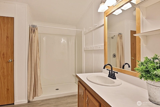 5845 Alpha Ln, Freeland, WA 98249 - full bathroom with a shower stall, wood finished floors, vanity, and ornamental molding