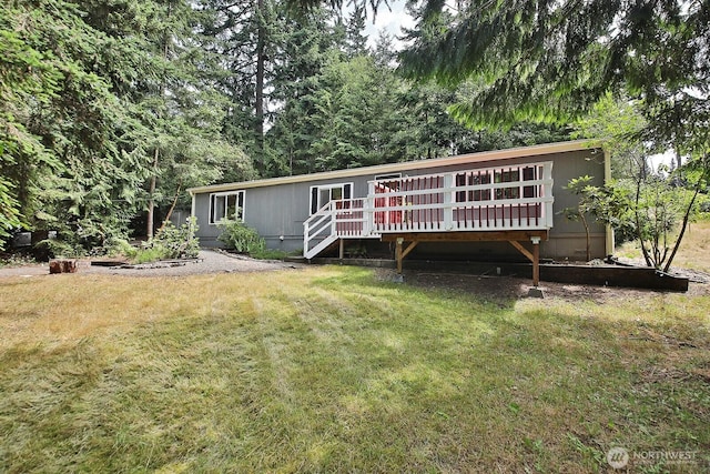 5845 Alpha Ln, Freeland, WA 98249 - view of front facade featuring a wooden deck and a front yard