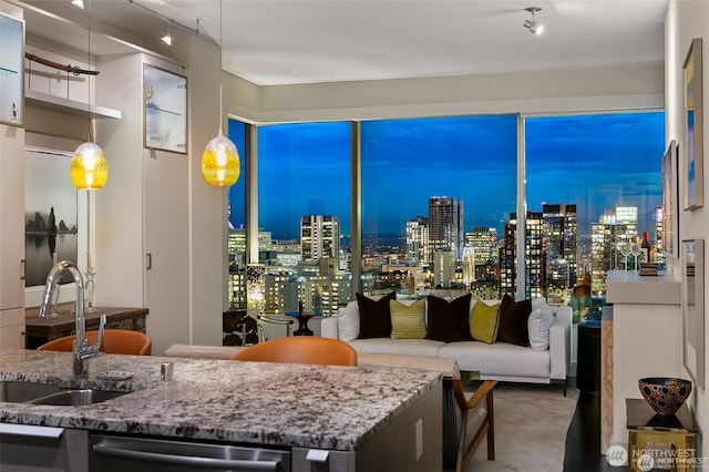 737 Olive Way Unit 3606, Seattle, WA 98101 - kitchen featuring stainless steel dishwasher and stone counters
