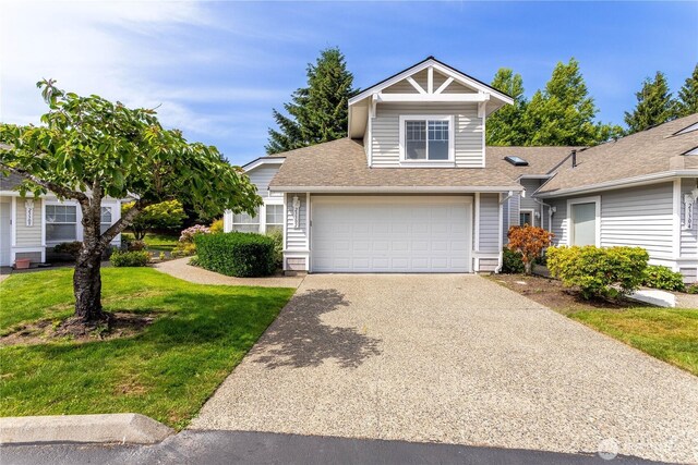 23302 53rd Ave S Unit 4-1, Kent, WA 98032 - view of front of home featuring concrete driveway, a front lawn, roof with shingles, and an attached garage