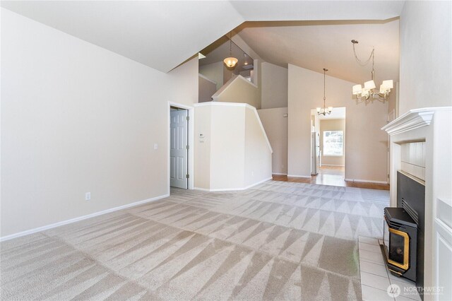 23302 53rd Ave S Unit 4-1, Kent, WA 98032 - unfurnished living room featuring high vaulted ceiling, a chandelier, carpet flooring, a fireplace, and a wood stove