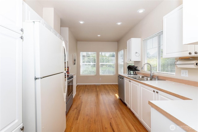 23302 53rd Ave S Unit 4-1, Kent, WA 98032 - kitchen with appliances with stainless steel finishes, light wood-style flooring, white cabinetry, plenty of natural light, and recessed lighting