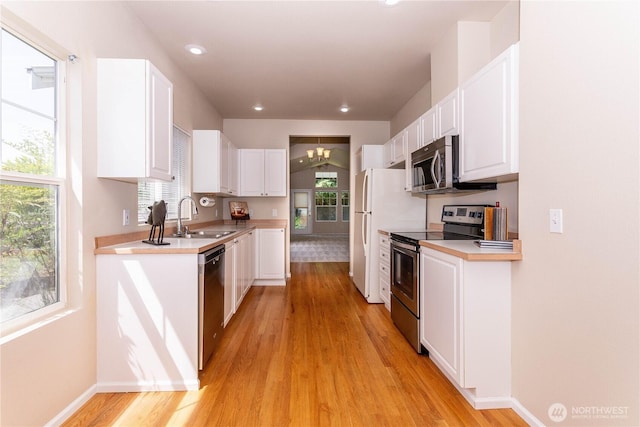 23302 53rd Ave S Unit 4-1, Kent, WA 98032 - kitchen with stainless steel appliances, light wood-style flooring, white cabinetry, light countertops, and recessed lighting