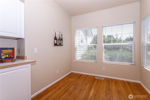 23302 53rd Ave S Unit 4-1, Kent, WA 98032 - unfurnished dining area featuring light wood-type flooring and baseboards