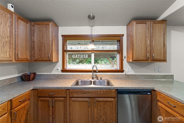 6137 189th Loop SW, Rochester, WA 98579 - kitchen featuring stainless steel dishwasher, brown cabinetry, pendant lighting, and a textured ceiling
