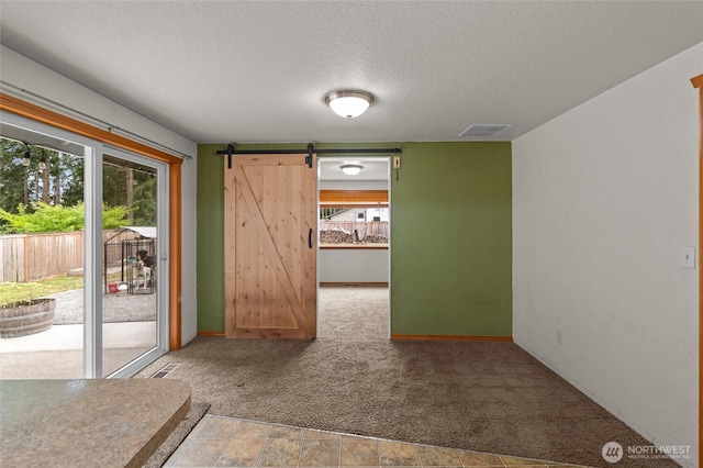 6137 189th Loop SW, Rochester, WA 98579 - carpeted empty room featuring a textured ceiling and a barn door