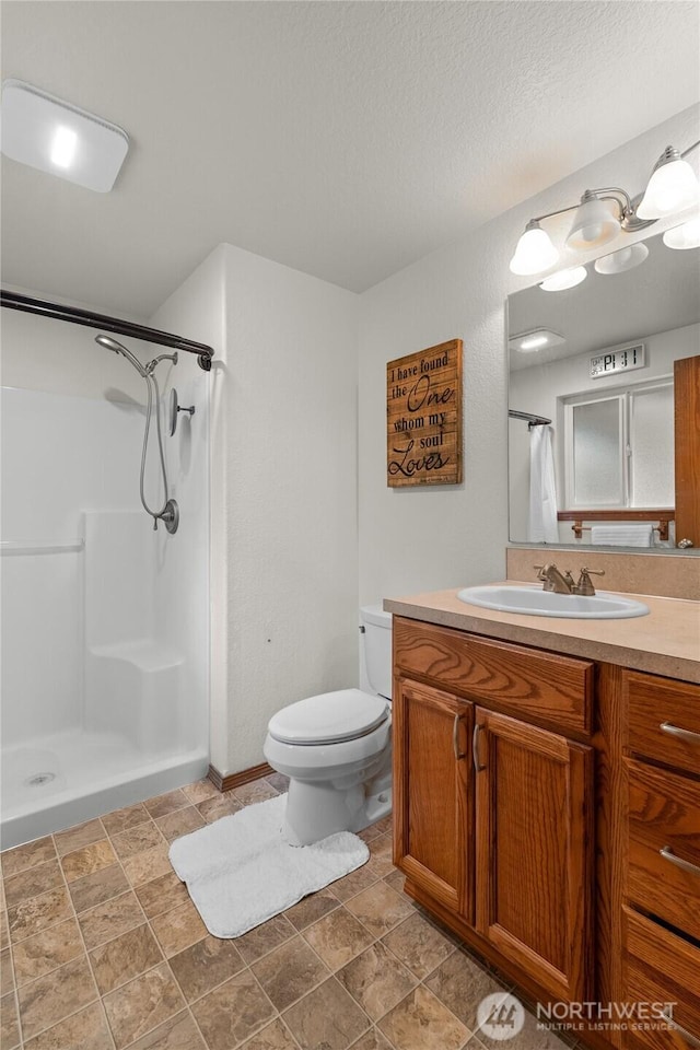 6137 189th Loop SW, Rochester, WA 98579 - full bathroom with a shower with shower curtain, vanity, and stone finish floors