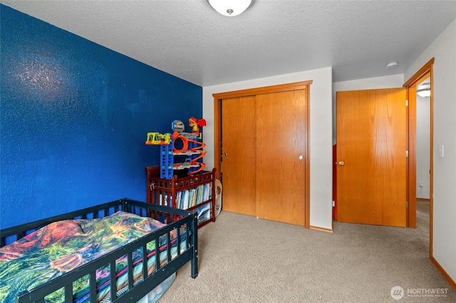 6137 189th Loop SW, Rochester, WA 98579 - bedroom with a textured ceiling, carpet flooring, and a closet