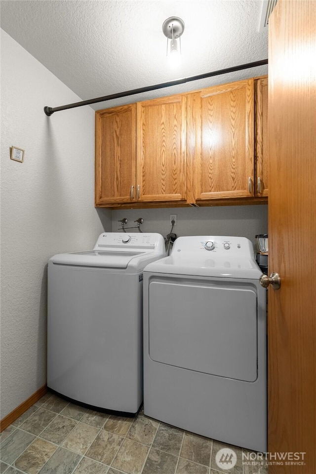 6137 189th Loop SW, Rochester, WA 98579 - washroom featuring cabinet space, washer and clothes dryer, and stone finish flooring
