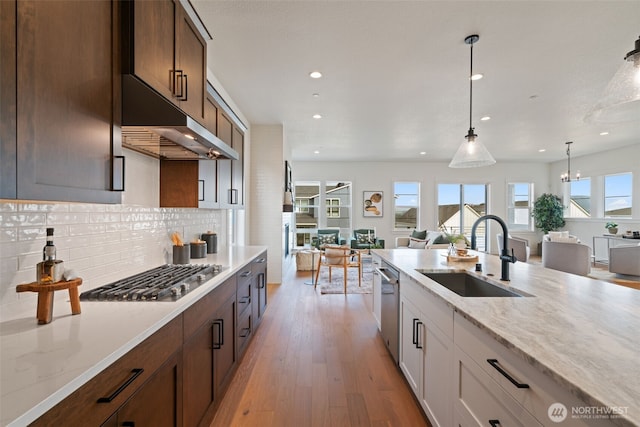 310 W Fir Loop, Washougal, WA 98671 - kitchen featuring appliances with stainless steel finishes, under cabinet range hood, open floor plan, recessed lighting, and light stone counters