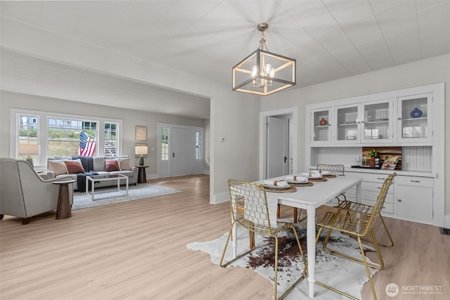 13806 Macadam Rd S, Tukwila, WA 98168 - dining space with light wood-type flooring and a chandelier