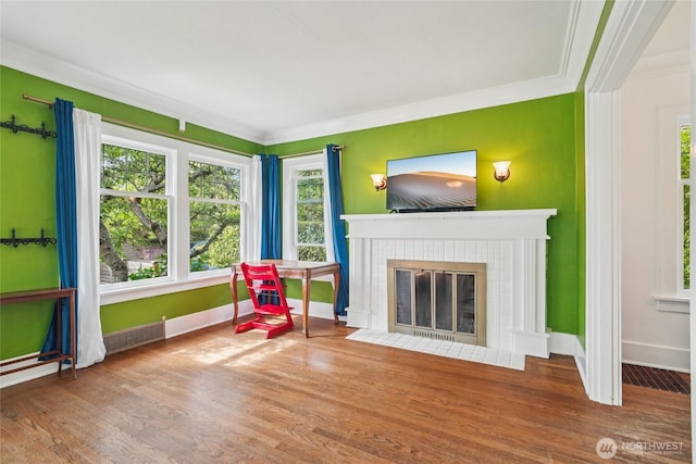 2726 34th Ave S, Seattle, WA 98144 - sitting room with wood finished floors, a tiled fireplace, and ornamental molding