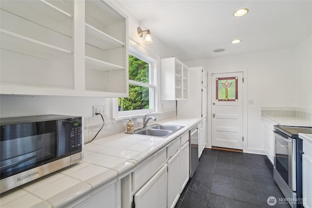 2726 34th Ave S, Seattle, WA 98144 - kitchen with open shelves, stainless steel appliances, tile counters, white cabinetry, and recessed lighting