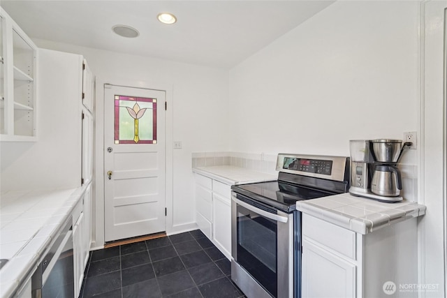 2726 34th Ave S, Seattle, WA 98144 - kitchen featuring stainless steel appliances, tile countertops, white cabinetry, dark tile patterned floors, and recessed lighting