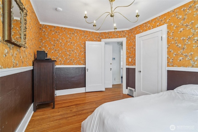 2726 34th Ave S, Seattle, WA 98144 - bedroom with wallpapered walls, wood finished floors, a chandelier, wainscoting, and crown molding