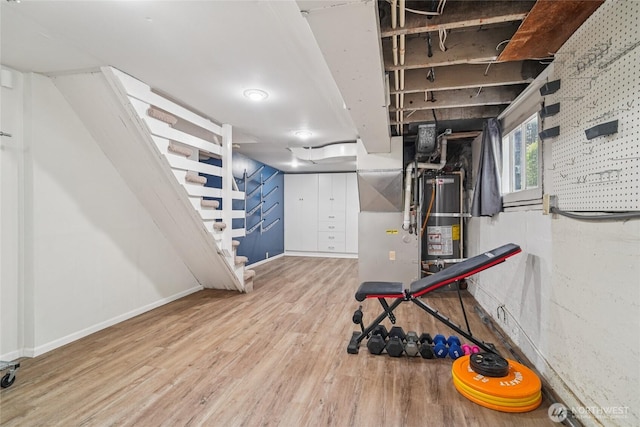 2726 34th Ave S, Seattle, WA 98144 - exercise room featuring water heater and wood finished floors