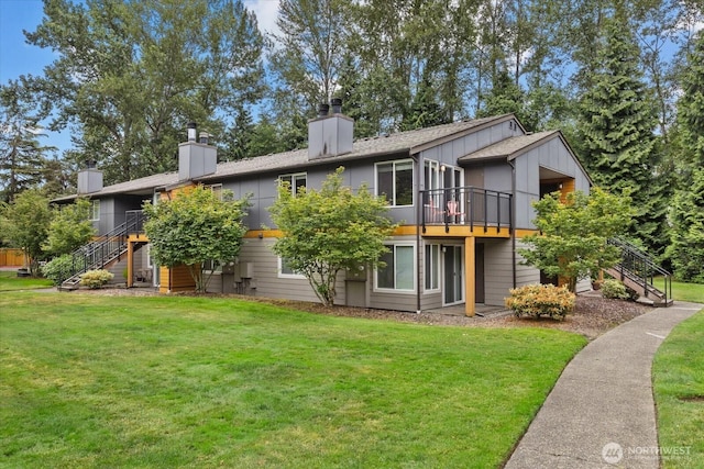 10831 NE 147th Ln Unit R202, Bothell, WA 98011 - rear view of property with stairs, a chimney, a lawn, and a deck