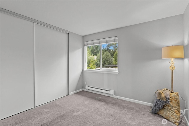 10831 NE 147th Ln Unit R202, Bothell, WA 98011 - unfurnished bedroom with baseboard heating, carpet flooring, and a closet