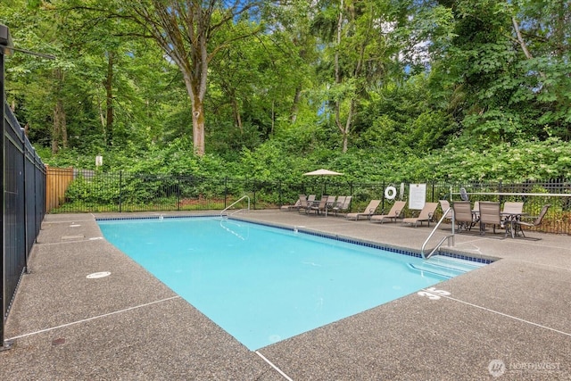 10831 NE 147th Ln Unit R202, Bothell, WA 98011 - community pool featuring a patio area, a fenced backyard, and outdoor dining area