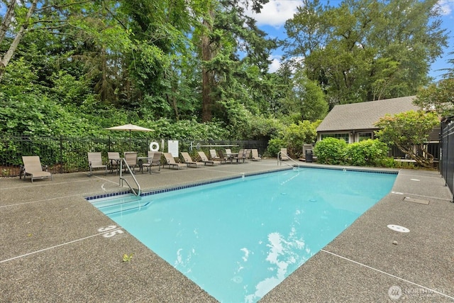 10831 NE 147th Ln Unit R202, Bothell, WA 98011 - community pool featuring a patio and view of wooded area