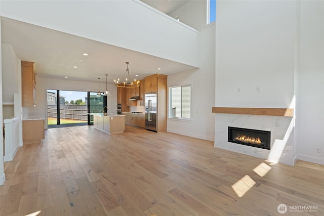 382 W Fir Loop, Washougal, WA 98671 - unfurnished living room featuring a fireplace, light wood finished floors, a chandelier, and recessed lighting