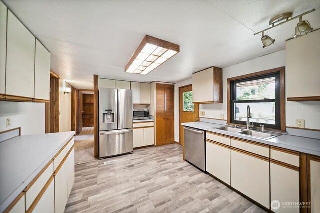 4960 SW Daisy St, Port Orchard, WA 98367 - kitchen with appliances with stainless steel finishes, light wood-style flooring, and light countertops
