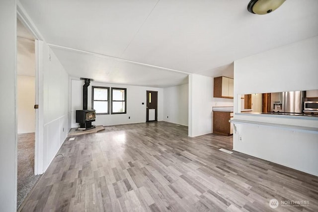 4960 SW Daisy St, Port Orchard, WA 98367 - unfurnished living room with a wood stove and wood finished floors
