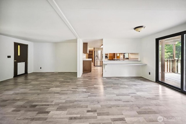 4960 SW Daisy St, Port Orchard, WA 98367 - unfurnished living room featuring wood finished floors and a sink