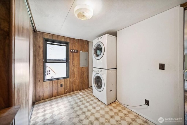 4960 SW Daisy St, Port Orchard, WA 98367 - laundry area featuring estacked washer and dryer, wood walls, and light floors
