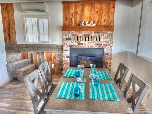 81 E Panorama Way, Grapeview, WA 98546 - dining room with a wall unit AC and wood finished floors
