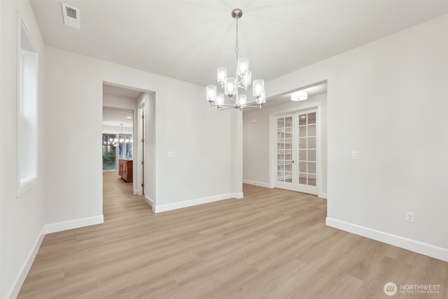 13600 100th St NE Unit 212, Lake Stevens, WA 98258 - unfurnished dining area with a chandelier, light wood-style floors, and french doors